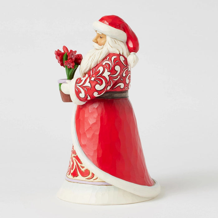 Side view of Santa figurine showing carved folk-art details and hand-painted patterns.