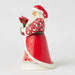 Side view of Santa figurine showing carved folk-art details and hand-painted patterns.