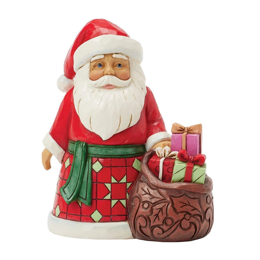 Front view of Jim Shore Santa with Toy Bag Pint Figurine holding gifts.