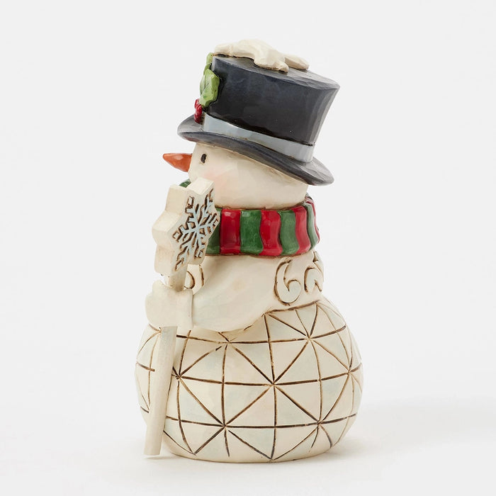 Side view of mini snowman holding a snowflake staff.