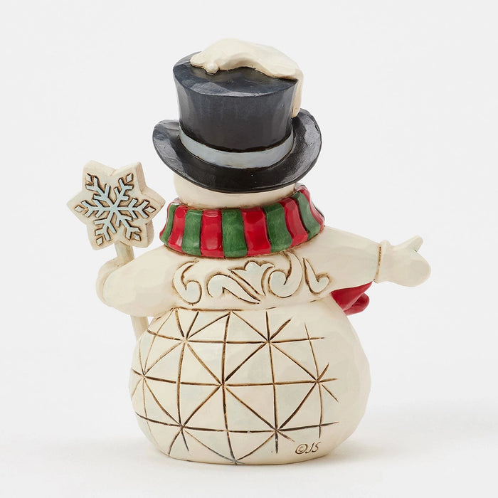 Back view showing hand-carved details and red-green scarf.