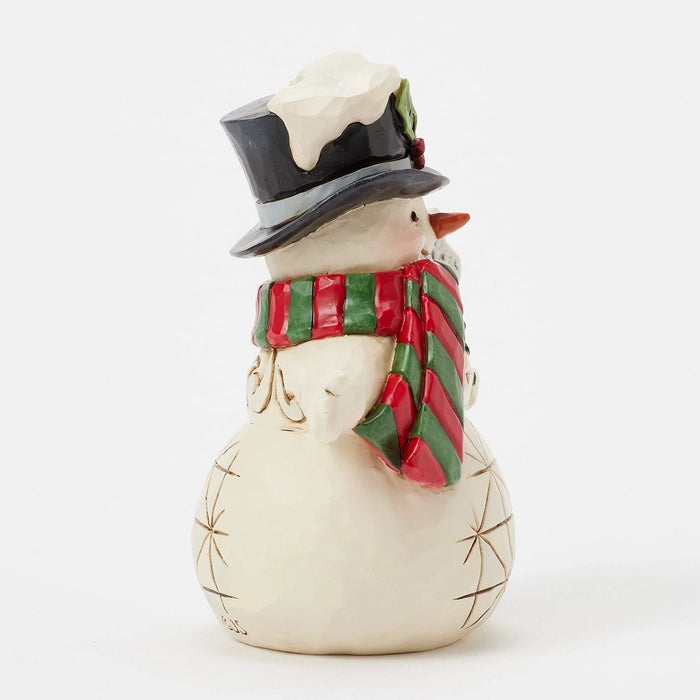 Side view of mini snowman holding a snowflake staff.