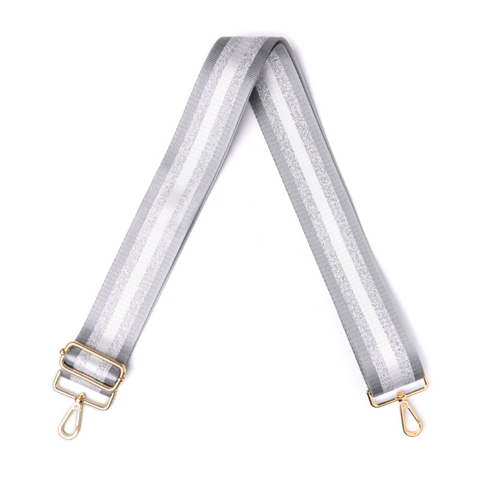 Silver glittery bag strap with gold hardware on a white background