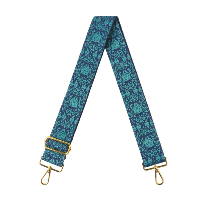 Blue floral patterned strap with gold hardware on a white background