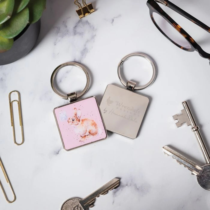 A pink keychain adorned with a rabbit, perfect for adding charm to your keyring.