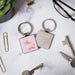 A pink keychain adorned with a rabbit, perfect for adding charm to your keyring.