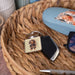 A square key chain displays a dachshund dog, highlighting its unique shape and charming personality.