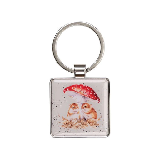 A square keychain featuring two owls standing together under a colorful umbrella.