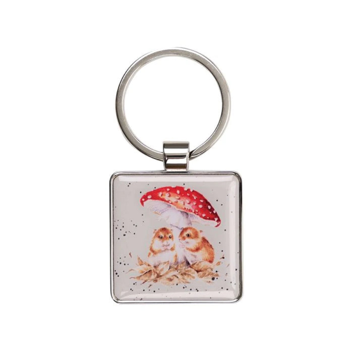 A square keychain featuring two owls standing together under a colorful umbrella.
