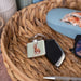 A square keychain adorned with an illustration of a rabbit.