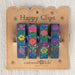 Three decorative clothespins featuring floral embellishments, set against a plain backdrop.