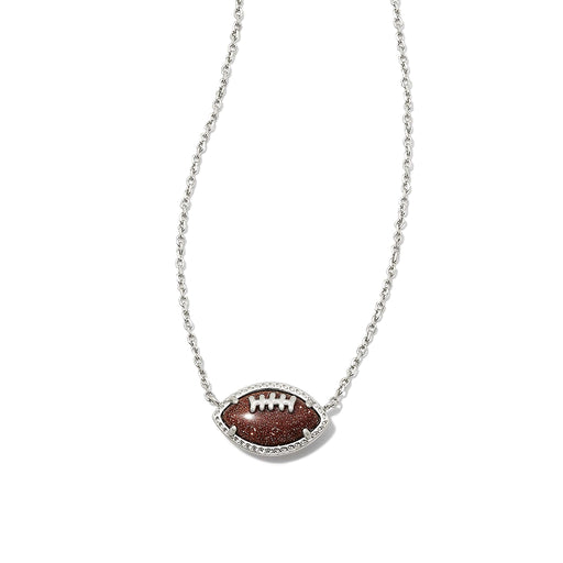 Close-up of Kendra Scott football pendant necklace featuring orange goldstone football set in silver