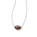 Close-up of Kendra Scott football pendant necklace featuring orange goldstone football set in silver