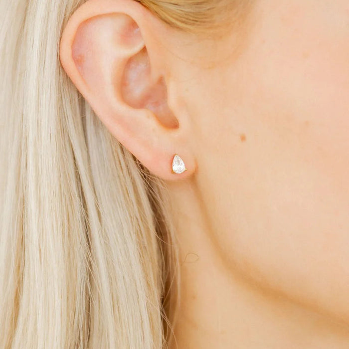 The Paige Pear Screwback Stud Earrings feature a stunning 6mm pear-shaped CZ stone, offering a timeless and elegant look.