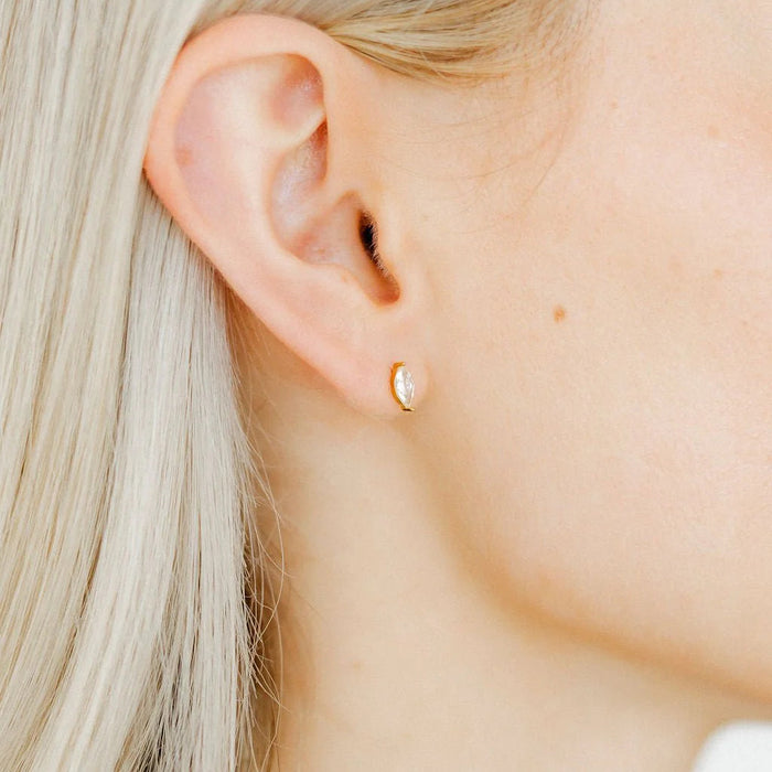 The Maeve Screwback Stud Earrings feature a stunning 8mm CZ Marquis stone, set with elegant gold prongs for a touch of luxury. 