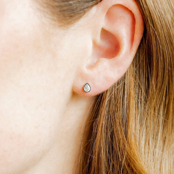 The Paloma Pear Silver Screwback Stud Earrings offer a refined and elegant design with a modern twist.