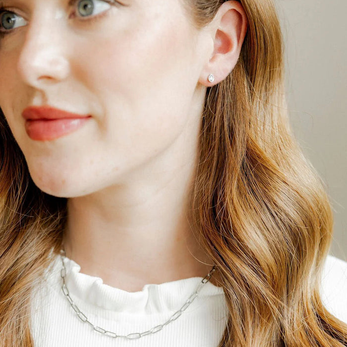 The Paloma Pear Silver Screwback Stud Earrings offer a refined and elegant design with a modern twist.