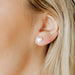  Sweet and timeless, the Lucia Small Screwback Stud Earrings feature a delicate heart-shaped synthetic pearl design that adds a soft, feminine touch to any look. 