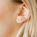  the Clara Cross Screwback Stud Earrings feature 7mm petite pearl-like beads arranged in a delicate cross silhouette. 