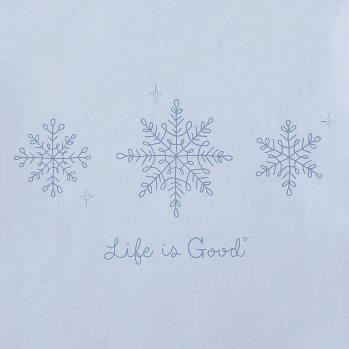 Close-up of Life Is Good Doodle Snowflakes graphic featuring three hand-drawn snowflakes and logo on soft blue fabric.