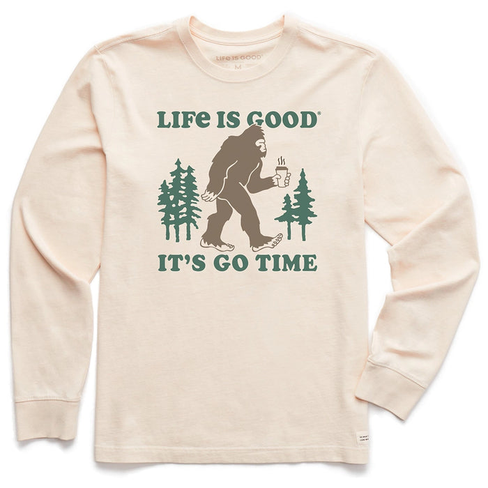 Life Is Good It’s Go Time Long Sleeve Tee – cream men’s shirt featuring Bigfoot holding coffee with pine trees.
