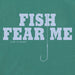 Close-up of Life is Good Fish Fear Me Crusher Tee – men's green fishing t-shirt with hook graphic and bold slogan