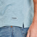 Close-up of Life is Good label on Super Fly Slim Fit Tee – light blue men's shirt with side vent and logo patch detail