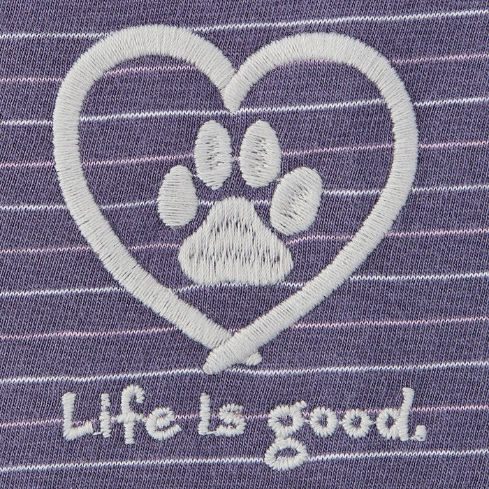 Close-up of embroidered white paw print inside heart with “Life is good” text on purple striped fabric