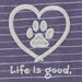 Close-up of embroidered white paw print inside heart with “Life is good” text on purple striped fabric