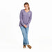 Full-body view of woman wearing Life Is Good Women’s Pet Paw Crusher Hooded Tee in purple stripes, paired with jeans