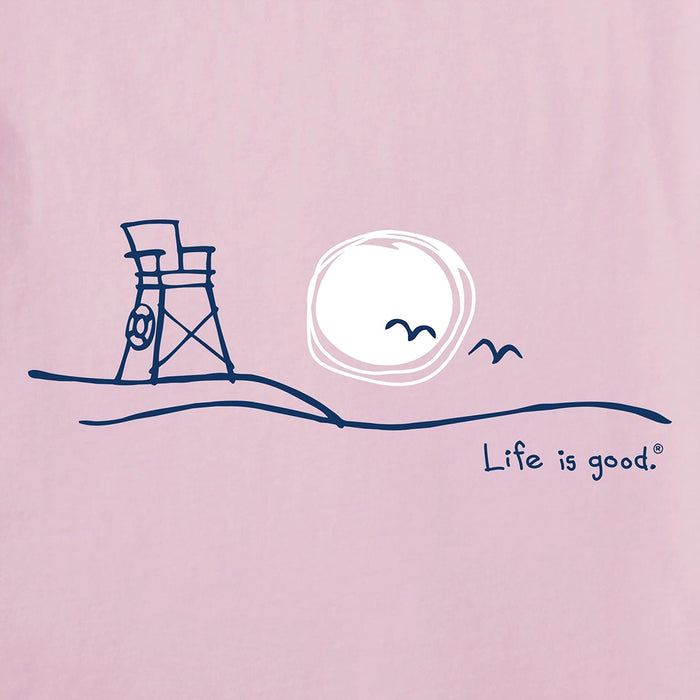 Life Is Good Women's Roam Beach Crusher Tee graphic close-up featuring minimalist lifeguard chair, sun, and seagulls on soft pink cotton fabric