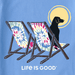 Life Is Good women's Tie Dye Dog Beach Chairs Crusher Tee graphic featuring a black dog sitting on colorful tie-dye beach chairs under the sun.