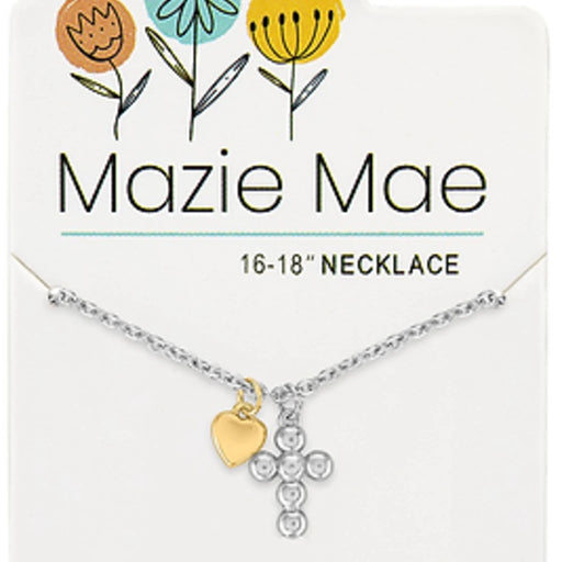 A close-up of a maze cross necklace, showcasing its detailed pattern and shiny finish, displayed on a neutral surface.