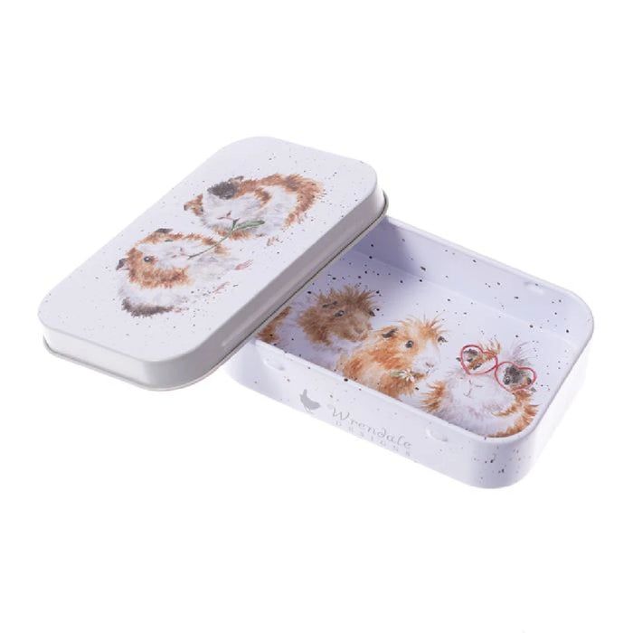 A decorative tin box featuring a whimsical cat design on its surface.