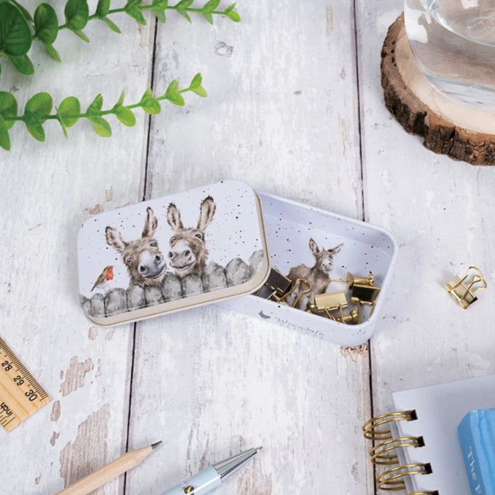 A decorative tin box adorned with a picture of a deer alongside a rabbit.