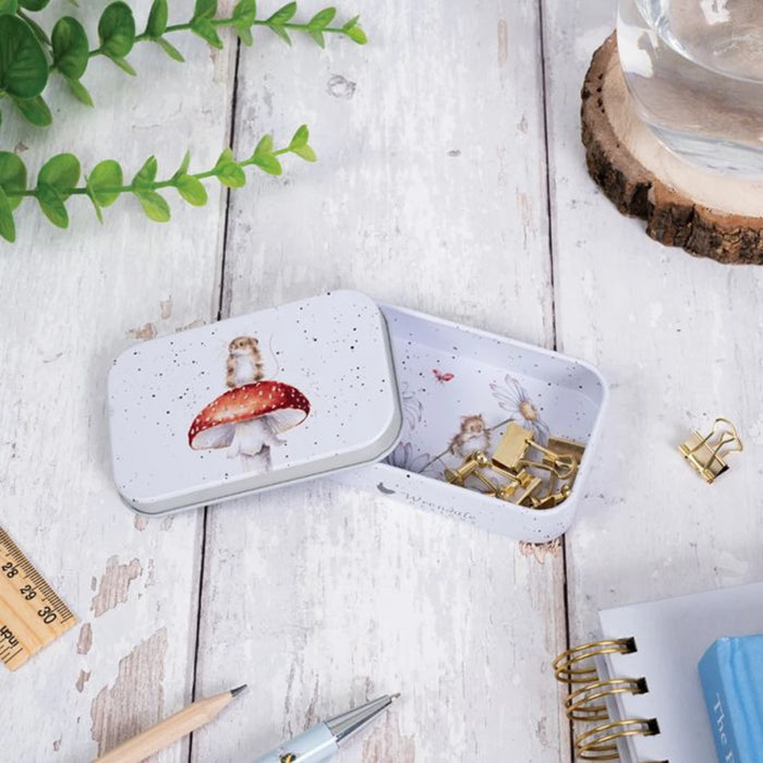 A small tin box featuring a decorative flower design on its surface.