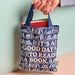 Reusable tote bag featuring "It's A Good Day To Read A Book" design for book lovers and everyday use.