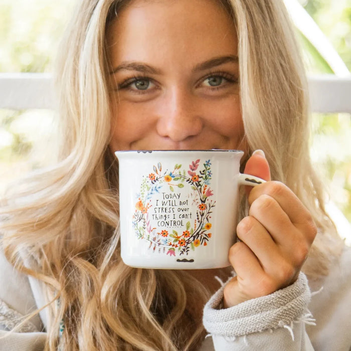 A ceramic coffee mug displaying a motivational quote in elegant typography.