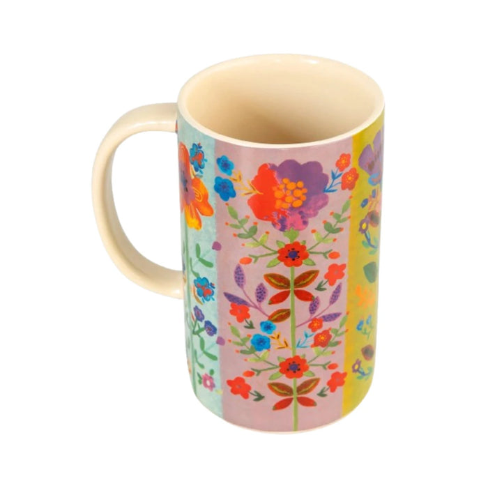 A vibrant floral patterned mug featuring a colorful design with various flowers and leaves.