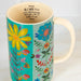 A colorful mug decorated with a lively floral pattern, highlighting a mix of vibrant flowers and artistic details.