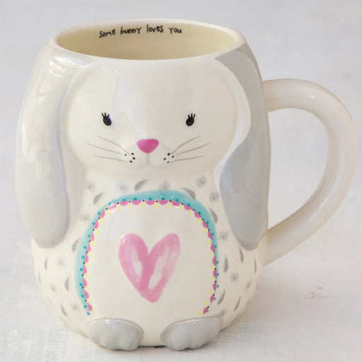 A white ceramic mug adorned with a playful bunny illustration, ideal for coffee or tea lovers.