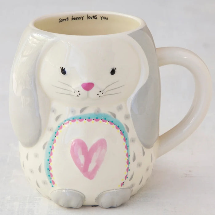 A white ceramic mug adorned with a playful bunny illustration, ideal for coffee or tea lovers.