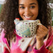 A colorful chicken design embellishes this charming ceramic mug.