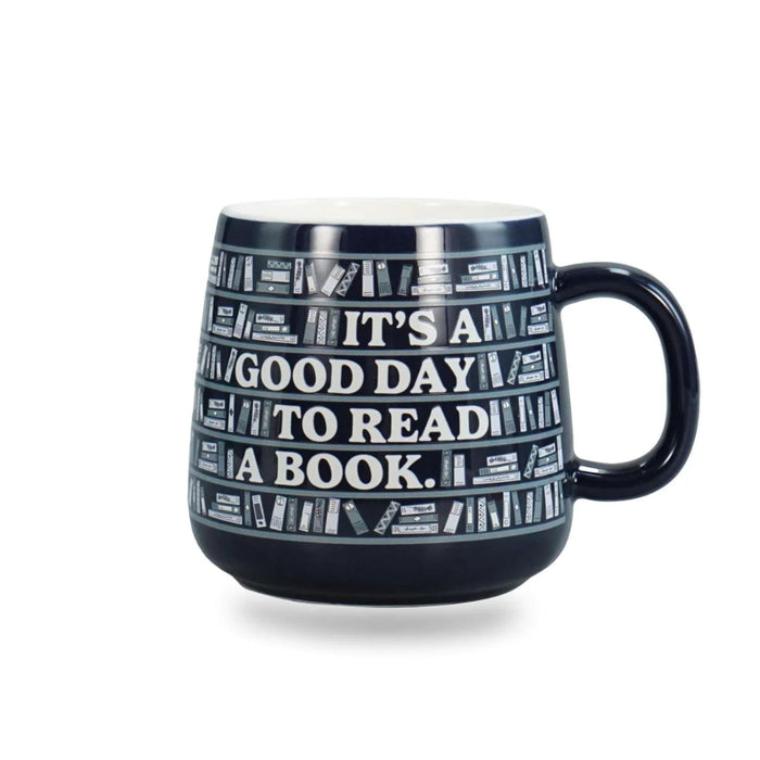 Ceramic mug featuring "It's A Good Day To Read A Book" quote for book lovers enjoying coffee or tea.