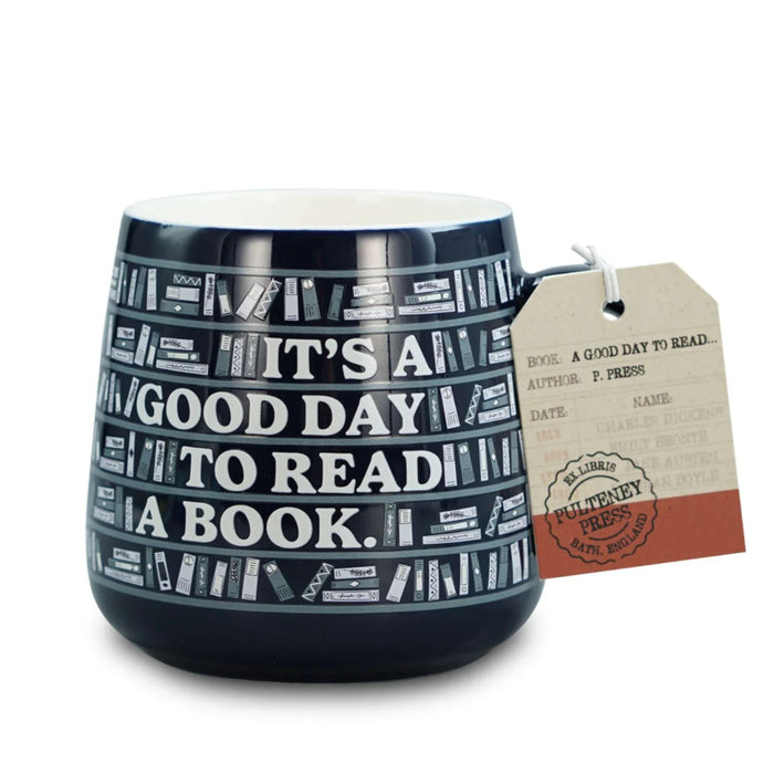 Ceramic mug featuring "It's A Good Day To Read A Book" quote for book lovers enjoying coffee or tea.
