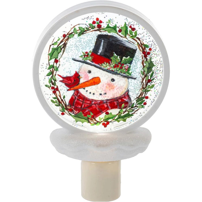 beautiful night light with a snowman and a cardinal on his carrot top nose.