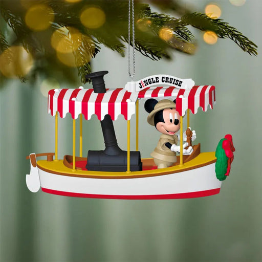 Christmas ornament of a character on a boat with a red and white striped canopy, hanging from a tree.