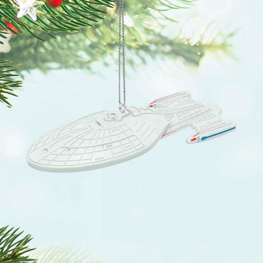 Star Trek ship ornament hanging on a Christmas tree