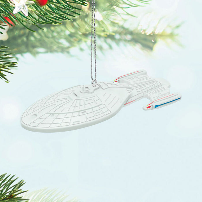 Star Trek ship ornament hanging on a Christmas tree