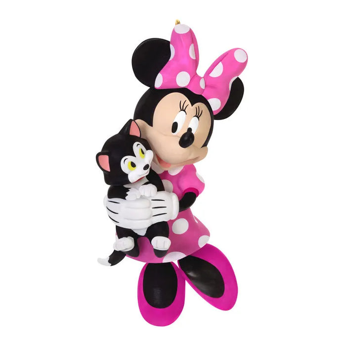White background studio shot of Minnie Mouse holding Figaro cat in fuchsia polka-dot dress ornament